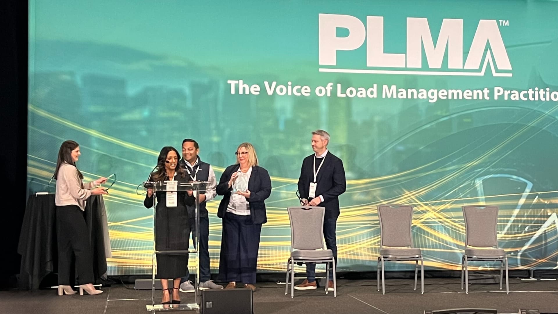 Representatives of Ontario IESO, EnergyHub, ecobee, and Oracle on stage receiving a Pacesetter Award at the 49th PLMA conference